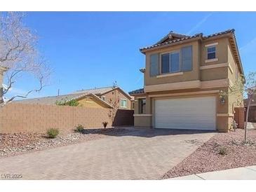 Tan two-story house with attached garage and landscaped front yard at 772 Crimson Peak Pl, Henderson, NV 89011