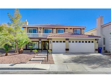 Two-story house with a three-car garage and a landscaped front yard at 7978 Coronado Coast St, Las Vegas, NV 89139