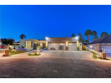 Luxury home with modern design, showcasing a spacious driveway and landscape at 8104 Via Del Cerro Ct, Las Vegas, NV 89117