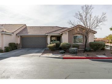 Single-story home with attached garage and well-manicured landscaping at 8634 Lakota St, Las Vegas, NV 89123