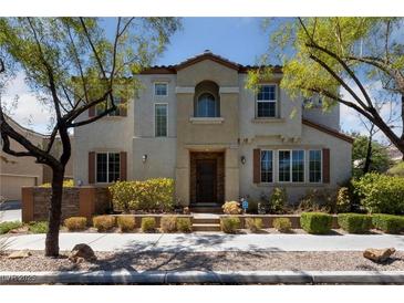 Two-story house with a landscaped yard and attractive curb appeal at 9048 Rich Amethyst Ct, Las Vegas, NV 89149