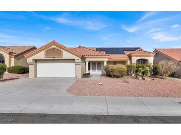 Single-story house with solar panels and a two-car garage at 9308 Cactus Wood Dr, Las Vegas, NV 89134