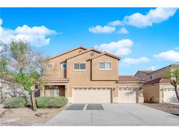 Two-story house with beige exterior, three-car garage, and landscaping at 2314 Rock Slide Cir, Las Vegas, NV 89115