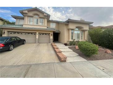 Two-story house with attached two-car garage and landscaped front yard at 2438 Ping Drive, Henderson, NV 89074