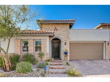 Single-story home with stone accents and a two-car garage at 251 Castellari Dr, Las Vegas, NV 89138