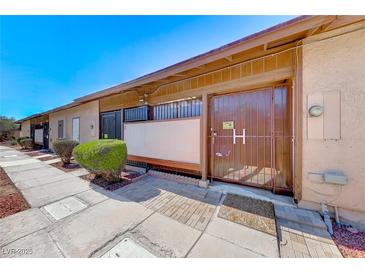 Building exterior featuring a walkway and gated entry at 3024 Saint George St # H, North Las Vegas, NV 89030