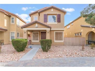 Two-story house with brown accents and landscaped front yard at 5738 Wind Tower St, North Las Vegas, NV 89031