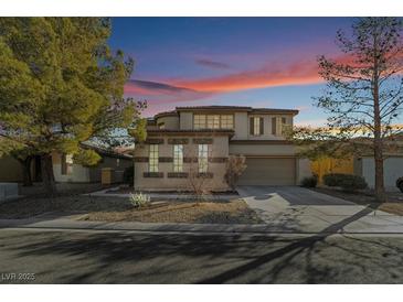 Two-story house with a landscaped yard, two-car garage, and charming curb appeal at 9236 Arbor Glen St, Las Vegas, NV 89123