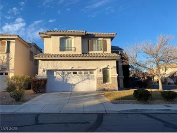 Two-story house with attached garage and landscaped yard at 10332 Splendor Ridge Ave, Las Vegas, NV 89135