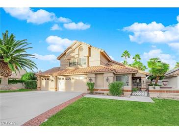 Two-story house with a two-car garage and landscaped front yard at 1968 Revere Ct, Henderson, NV 89014