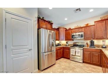 Modern kitchen with stainless steel appliances and wood cabinets at 2408 Sky Watcher St, Henderson, NV 89044