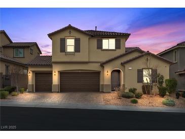 Two-story house with brown doors and shutters, a paved driveway, and landscaping at 2571 Hazelburn Ave, Henderson, NV 89044