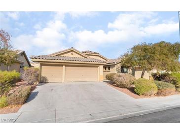 Single-story home with three-car garage and landscaped yard at 3008 Blush Noisette Ave, North Las Vegas, NV 89081