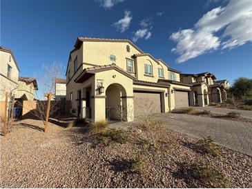 Two-story townhome with attached garage and desert landscaping at 315 Bay Village Pl, Henderson, NV 89011