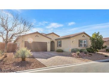 Single-story home with a brown garage door and landscaped front yard at 315 Rhiannon Ct, Las Vegas, NV 89183