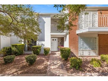 Charming townhome with manicured landscaping, brick accents, and private balconies at 656 Tam O Shanter, Las Vegas, NV 89109