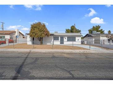 Updated single story home with a fenced front yard at 2028 Hassell Ave, North Las Vegas, NV 89032
