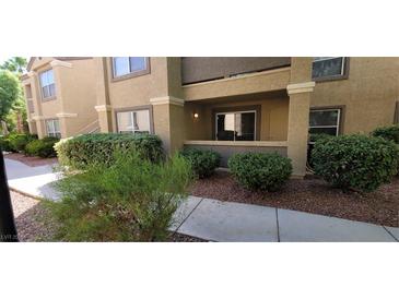 Tan colored building exterior with landscaping and walkway at 2300 E Silverado Ranch Blvd # 1151, Las Vegas, NV 89183