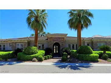 Stunning ranch-style home with stone accents and lush landscaping at 4638 Evan Ridge Ct, Las Vegas, NV 89129
