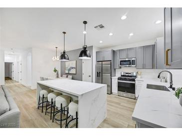 Modern kitchen with stainless steel appliances and white quartz countertops at 9100 Kings Town Ave, Las Vegas, NV 89145