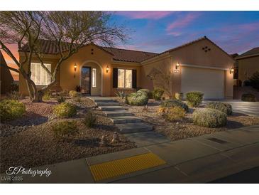 Beautiful desert landscaping surrounds this one-story home with a Spanish-style facade at 993 Starlight Terrace Way, Mesquite, NV 89034