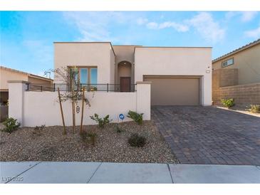 Single-story home with modern facade, two-car garage, and landscaped front yard at 11707 Hatchling Ave, Las Vegas, NV 89138