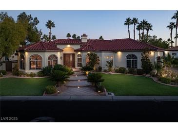 Elegant single-story home with red tile roof, landscaped lawn, and palm trees at 2204 Glenbrook Way, Las Vegas, NV 89117