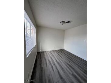 Bright living room with gray vinyl flooring and large windows at 521 S Maryland Pkwy # A10, Las Vegas, NV 89101