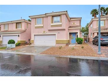 Charming two-story home featuring a blue front door and a well-maintained, low maintenance landscaped yard at 9247 Tulip Trestle Ave, Las Vegas, NV 89148