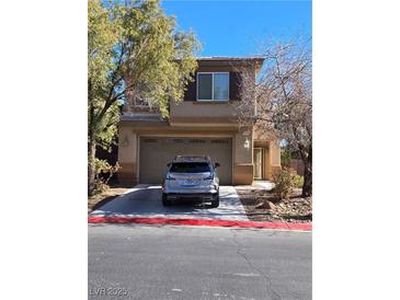 Two-story house with attached garage and landscaping at , North Las Vegas, NV 89081