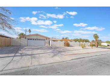 Single story home with attached two-car garage and landscaped front yard at 3829 Delaware Ln, Las Vegas, NV 89169