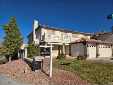 Two-story house with a three-car garage and landscaped yard at 502 Pale Pueblo Ct, Las Vegas, NV 89183