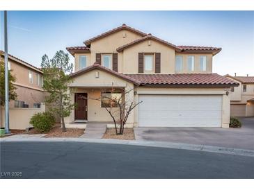 Two-story house with attached garage and desert landscaping at 6005 Bristol Crest Ln, Las Vegas, NV 89139