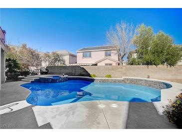 Inviting kidney-shaped pool with a waterfall feature at 10150 Timber Willow Ave, Las Vegas, NV 89135