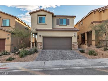 Two-story house with a two-car garage and landscaped front yard at 10931 Cambridge Lakes Ave, Las Vegas, NV 89166