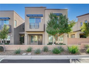 Modern two-story home with landscaped front yard and two-car garage at 11275 Idyllic Dr # 101, Las Vegas, NV 89135