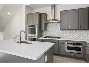 Modern kitchen with gray cabinets, stainless steel appliances, and quartz countertops at 11809 Stone Run Ave, Las Vegas, NV 89138