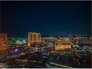 Nighttime aerial view of illuminated cityscape, showcasing modern high-rise buildings and city lights at 2000 Fashion Show Dr # 5428, Las Vegas, NV 89109