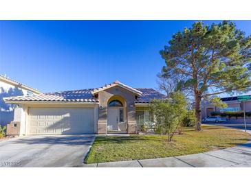 One-story house with a two-car garage and landscaped front yard at 2044 Glorieta Ln, Las Vegas, NV 89134