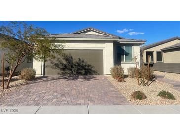 Single-story house with brown garage door and landscaped front yard at 2254 Cold Canyon Ave, North Las Vegas, NV 89086