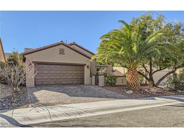 Single-story house with brown garage door and landscaped front yard at 2401 Weaverville Dr, Henderson, NV 89044