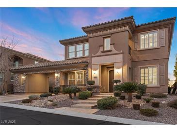 Two-story house with stone accents, and a three-car garage at 2717 Mona Lisa St, Henderson, NV 89044