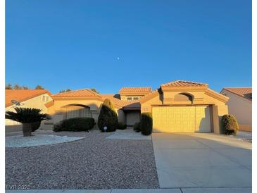 Single-story house with a two-car garage and desert landscaping at 3012 Morning Ridge Dr, Las Vegas, NV 89134