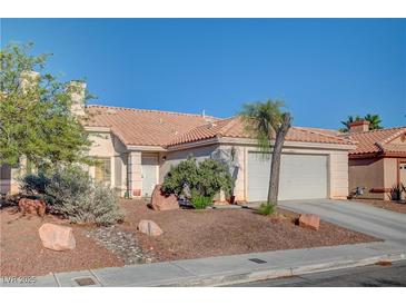 Single-story home with a two-car garage and desert landscaping at 3790 Morning Canyon St, Las Vegas, NV 89147