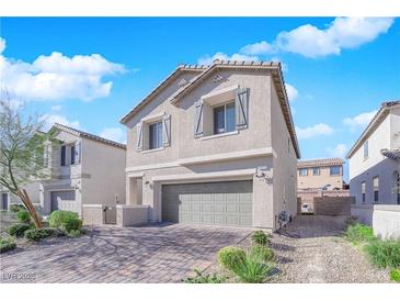 Two-story house with gray siding, a two-car garage, and a paved driveway at 4823 Kinworthy St, North Las Vegas, NV 89081