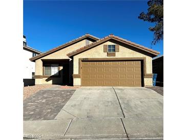 Single-story house with a two-car garage and a paved driveway at 6560 Bush Clover Ln, Las Vegas, NV 89156