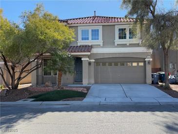 Two-story house with taupe exterior, attached garage, and landscaping at 6607 Musette Ave, Las Vegas, NV 89139