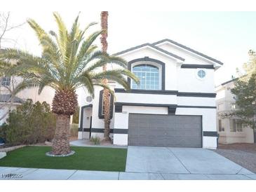 Two-story house with gray garage door and palm trees at 7409 Flat Rock St, Las Vegas, NV 89131