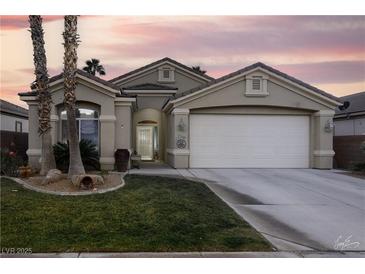 Single-story home with a two-car garage and landscaped yard at 750 Arguello Cir, Mesquite, NV 89027