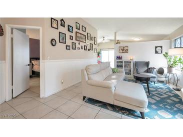 Bright living room featuring a comfy sectional sofa and gallery wall at 1861 Ridgefield Dr, Las Vegas, NV 89108